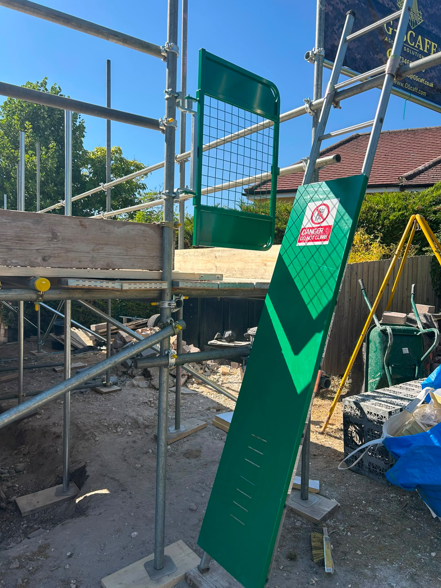 Scaffold ladder access gate and Danger Do Not Climb signage on a G-Scaff residential extension scaffold
